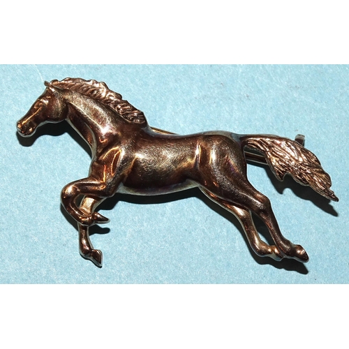 452 - A 9ct gold brooch in the form of a galloping horse, 40mm, 4.5g.