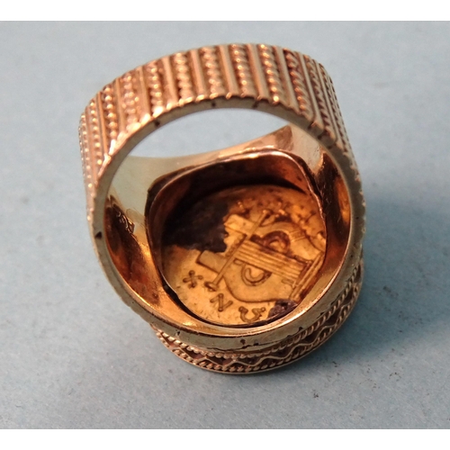 479 - A gentleman's 18ct gold ring inset a Greek gold coin, (solder visible on back), size O, 21.6g.... 