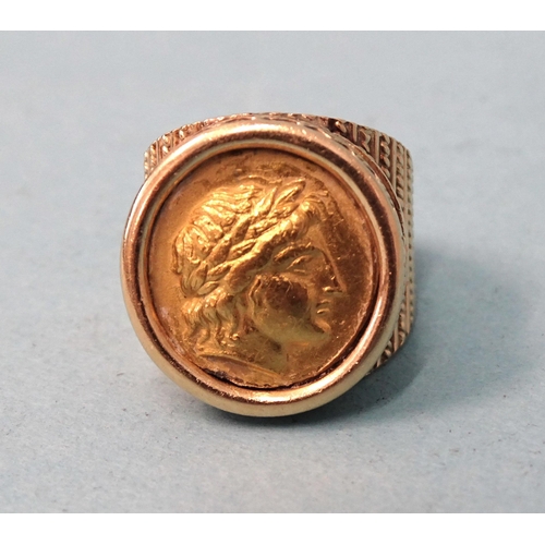 479 - A gentleman's 18ct gold ring inset a Greek gold coin, (solder visible on back), size O, 21.6g.... 