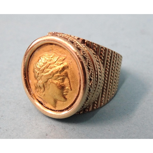 479 - A gentleman's 18ct gold ring inset a Greek gold coin, (solder visible on back), size O, 21.6g.... 