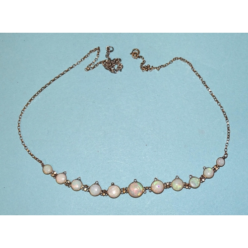 517 - An opal necklet of ten graduated round opals, in spectacle settings, (eight with vacant loop for dro... 