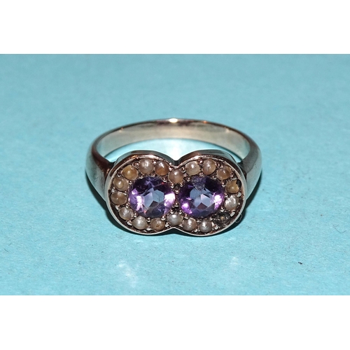 559 - A Victorian ring set two rondels of amethyst and seed pearl, unmarked, size J, 3g, (one seed pearl m... 