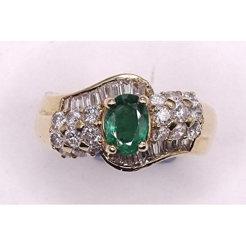 570 - An emerald and diamond cluster ring claw-set an oval emerald between two lines of keystone and bague... 