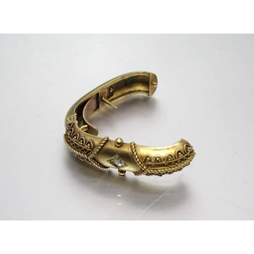 584 - A Victorian 15ct gold cravat clip of oval ring form, with cannetile decoration and set a brilliant-c... 