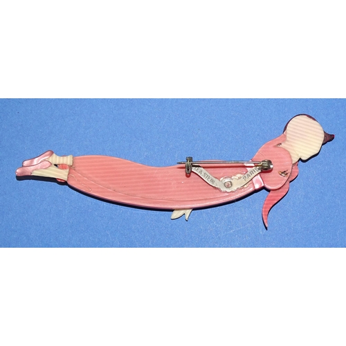 648 - Léa Stein, Paris, a ‘Tennis Woman’ or ‘Diver’ brooch pin c1970’s depicting a lady in pink jumpsuit a... 