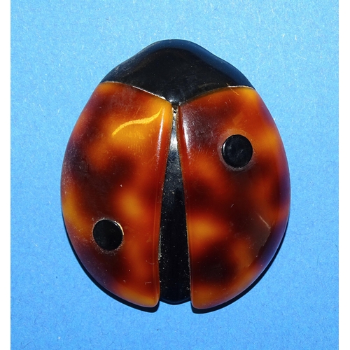 660 - Léa Stein, Paris, a black and red ladybug brooch pin c1990’s with two spots, 5.1cm high, a similar t... 