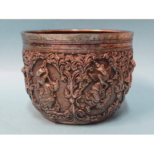 767 - A Burmese silver bowl deeply embossed with deities within scrolling arches, 12.5cm diameter, 9.5cm d... 