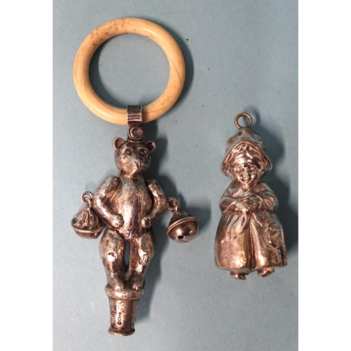 914 - A silver baby's rattle in the form of a teddy bear with bells at his elbows and bone teething ring, ... 