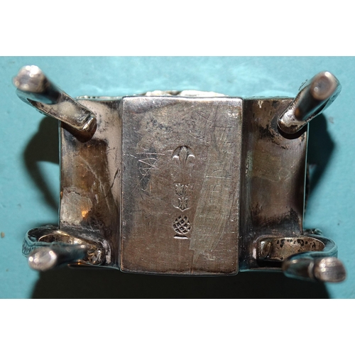 917 - A Continental silver pill box in the form of a worktable, on cabriole legs, with embossed decoration... 