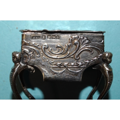 917 - A Continental silver pill box in the form of a worktable, on cabriole legs, with embossed decoration... 