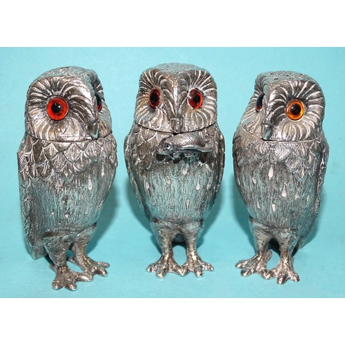 A novelty silver cruet in the form of three barn owls, with inset glass eyes, the mustard with mouse-finialled spoon hanging from the owl's beak, Richard Comyns, London 1972/4.