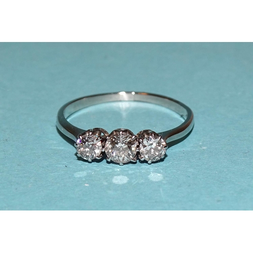 421 - A three-stone diamond ring claw-set old brilliant-cut diamonds, in unmarked white metal ring, (tests... 