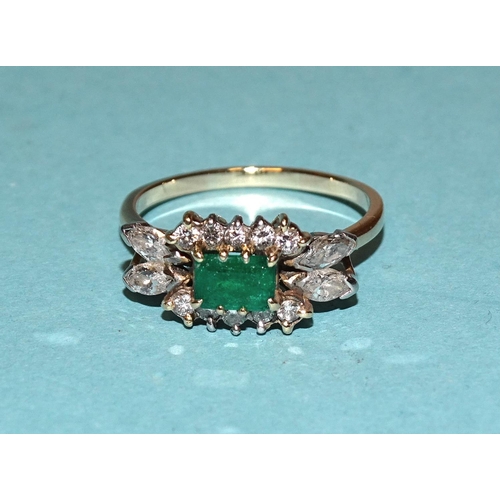 455 - An emerald and diamond cluster ring claw-set a rectangular emerald between two lines of five brillia... 