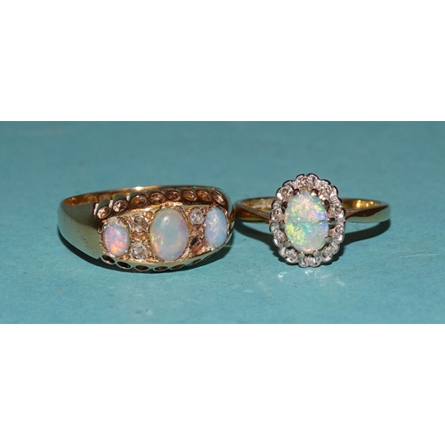 518 - A Victorian 18ct gold ring set two opals and three diamond points, (one opal replaced with glass, on... 