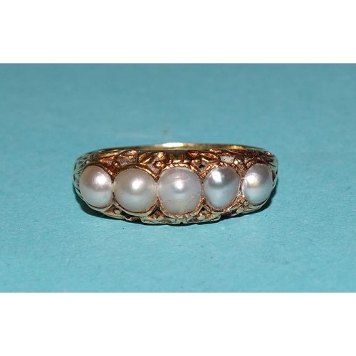 562 - A Victorian gold ring set five graduated demi-pearls, unmarked, tests as 18ct, size K½, 3.3g.... 