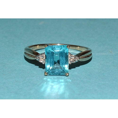 564 - A 9ct gold ring set rectangular blue topaz between diamond-point-set shoulders, size Q, 2.6g.... 