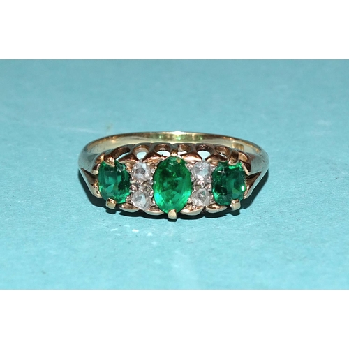 582 - A Victorian 18ct gold ring set one oval emerald and two soudé emeralds, with pairs of rose-cut diamo... 