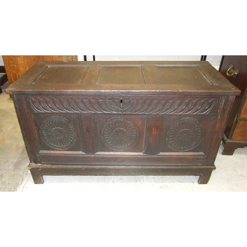 10 - A carved oak coffer, the panelled front carved with three roundels, 120cm wide, 68cm high.... 