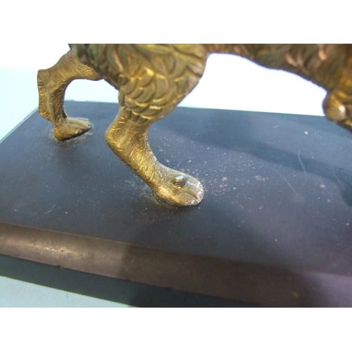 228 - A gilt metal figure of a sporting dog, on black marble base, 20cm long, 8cm high, the base 25 x 9cm.... 