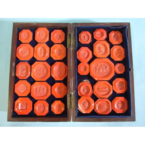 244 - A collection of sixty sealing wax seals contained in a mahogany double-folded box, box 18 x 11cm.... 