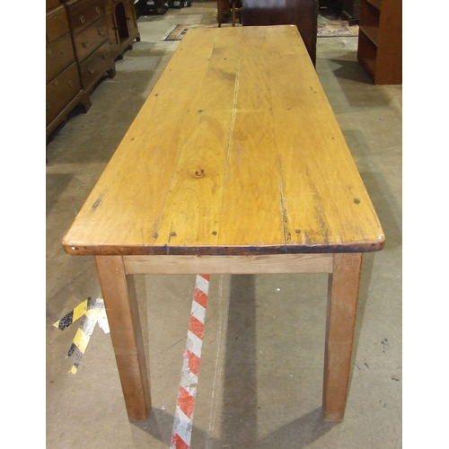 25 - A farmhouse kitchen table, the planked top above a single central frieze drawer, on square tapered l... 