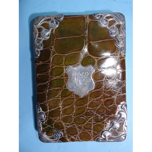 253 - An Art Nouveau silver-mounted green crocodile skin wallet, Birmingham 1900, 14 x 10cm.... 