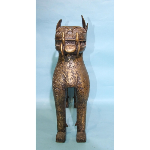 278 - A mid-20th century Benin-style model of a standing leopard, decorated overall with punch marks, 57cm... 