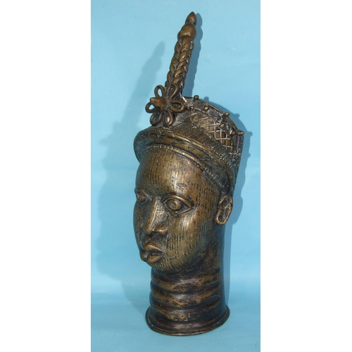 279 - A mid-20th century Benin-style bronze sculpture cast as a female head, 56cm high.