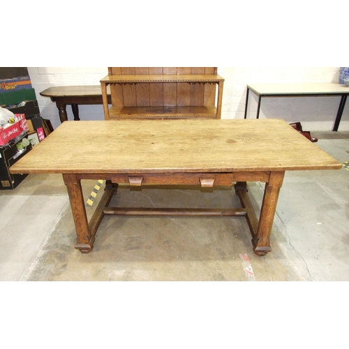 28 - An early-20th century Arts & Crafts oak dining table, the plank top above a single frieze drawer... 