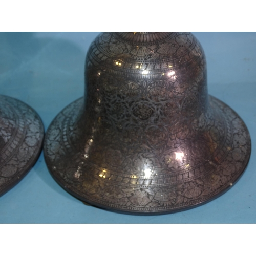 280 - A pair of Eastern table lamps, each turned wood column supported on a silvered Damascene metal bell-... 