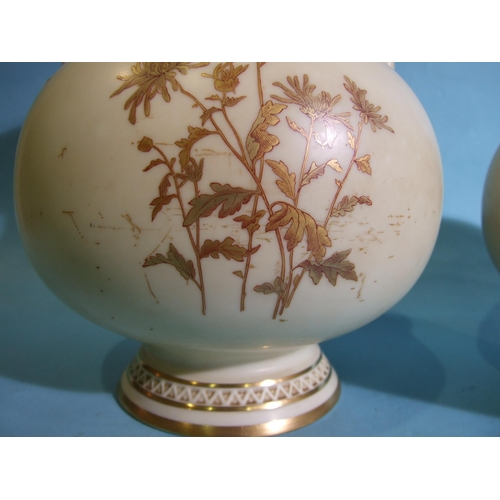 300 - A pair of Royal Worcester baluster-shaped two-handled vases, having a cup neck with gilt floral deco... 