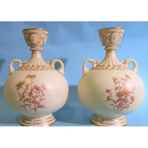 300 - A pair of Royal Worcester baluster-shaped two-handled vases, having a cup neck with gilt floral deco... 