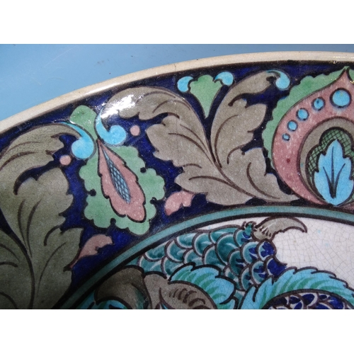 312 - A large Burmantofts Faience Iznik-style charger decorated with an eagle within a floral border, (rim... 