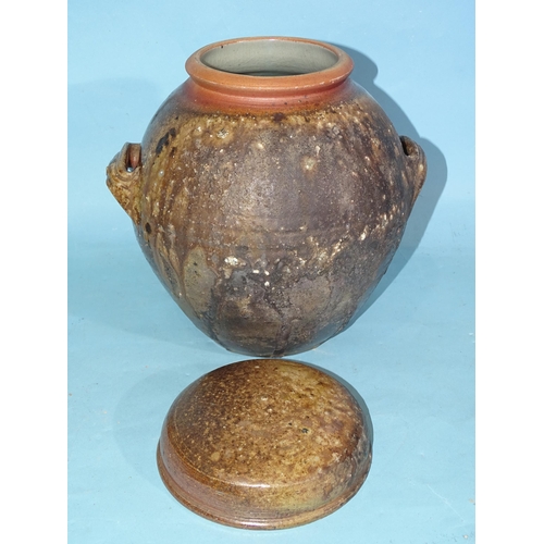 333 - A studio pottery two-handled storage jar and cover, 24cm high and a studio pottery vase incised 'GE'... 