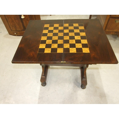 4 - An early-19th century rosewood games and worktable, the rectangular fold-over top with inlaid games ... 