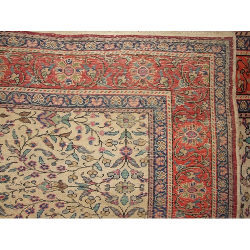 40 - A mid-20th century Persian rug, the camel centre profusely decorated with flowers and foliage, withi... 