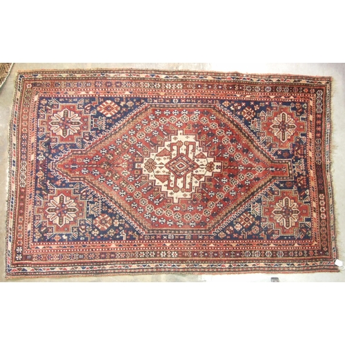 41 - A 20th century Persian wool rug, the central lozenge within a multiple border, on red and blue groun... 