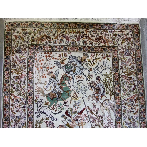 42 - A mid-20th century Persian silk pictorial rug, centrally decorated with figures on horseback hunting... 