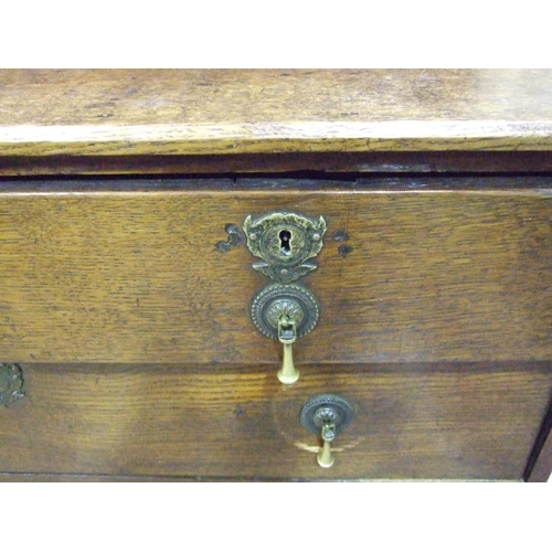 9 - An antique oak chest of two short and three long drawers, on bracket feet, 99cm wide, 90cm high.... 
