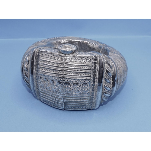 430 - An Omani white metal anklet with engraved decoration, 11 x 9.5 x 6.5cm.
