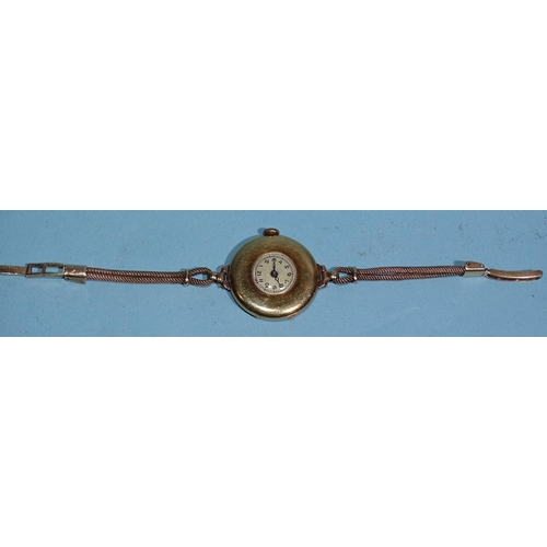 707 - A lady's 18ct gold-cased wristwatch, the circular face within wide plain bezel, with Swiss movement ... 