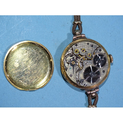 707 - A lady's 18ct gold-cased wristwatch, the circular face within wide plain bezel, with Swiss movement ... 