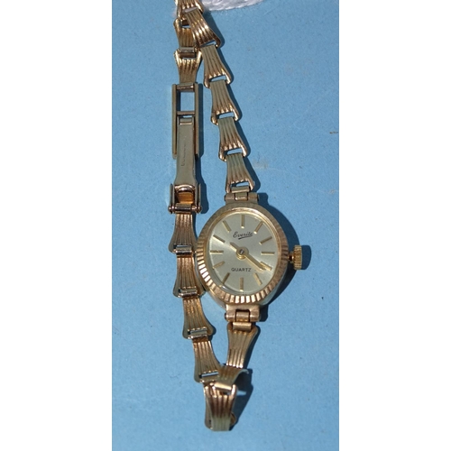 717 - A lady's 'Everite Quartz' 9ct gold wrist watch, the oval dial with baton numerals, in gold case with... 