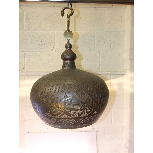 276 - A large Egyptian pierced metal hanging light bowl with extension hook, 70cm high approximately, 46cm... 