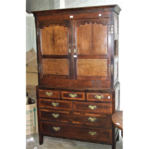 6 - An antique oak cupboard, having a pair of panelled doors above seven drawers, 110cm wide, 190cm high... 