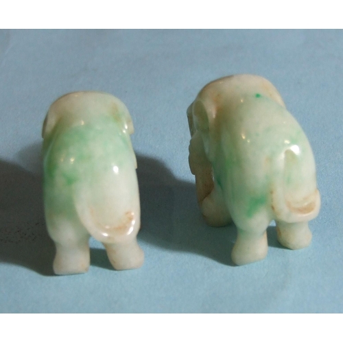 285 - Two carved jade elephants on stands, 4.8cm overall, (3).