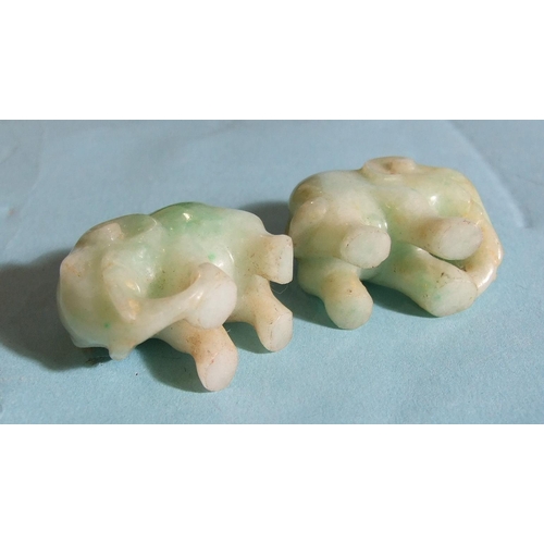 285 - Two carved jade elephants on stands, 4.8cm overall, (3).