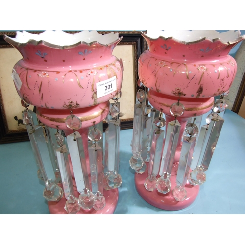 301 - A pair of Victorian pink opaque glass lustre vases with floral enamel and gilt painted decoration an... 