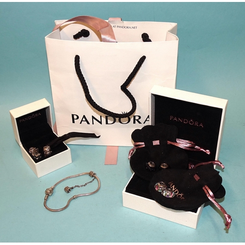 330 - Pandora, a silver charm bracelet with four silver-mounted glass charms and five others, with two box... 