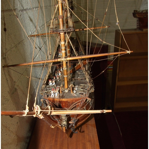 412 - A kit-built wooden model of a three-masted Norse warship, with deck detail including gun crews, 105c... 